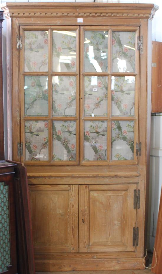 Late 18th century stripped pine glazed standing corner cupboard